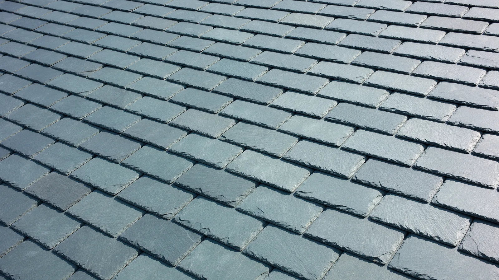 Close-up of new blue-grey Welsh slates laid in overlapping courses