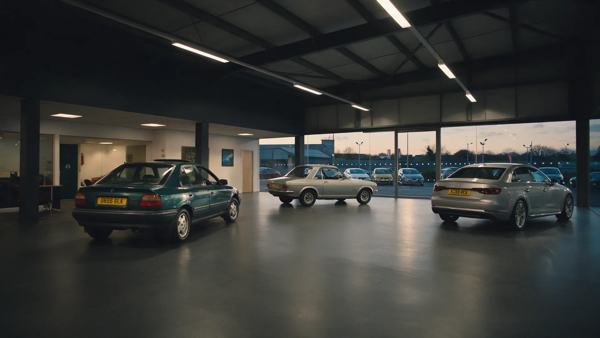 Inside the Valley Motor Company showroom with cars under the lights